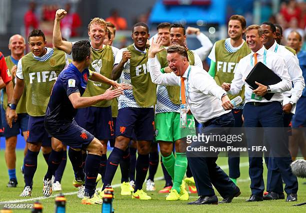 Robin van Persie of the Netherlands celebrates with coach Louis van Gaal of the Netherlands and team-mates after scoring a goal during the 2014 FIFA...