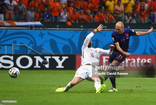 Arjen Robben of the Netherlands shoots and scores his team's second goal as Sergio Ramos of Spain defends in the second half during the 2014 FIFA...