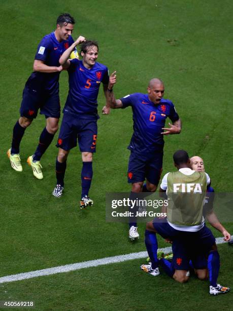 Arjen Robben of the Netherlands celebrates his teams second goal with Robin van Persie , Daley Blind and Nigel de Jong during the 2014 FIFA World Cup...
