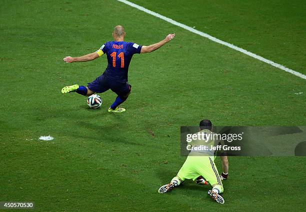 Arjen Robben of the Netherlands shoots and scores his second goal, the team's fifth, as goalkeeper Iker Casillas of Spain looks on during the 2014...