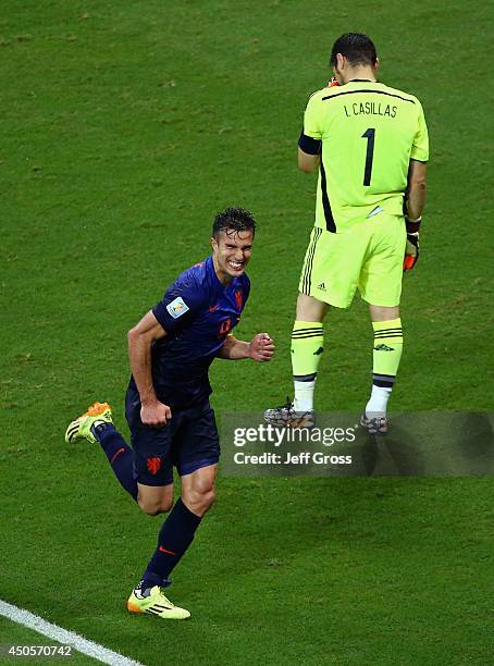 Robin van Persie of the Netherlands celebrates after scoring his second goal and his team's fourth as a dejected Iker Casillas of Spain looks on...