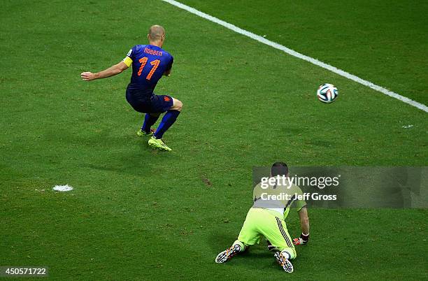 Arjen Robben of the Netherlands shoots and scores his second goal, the team's fifth, as goalkeeper Iker Casillas of Spain looks on during the 2014...