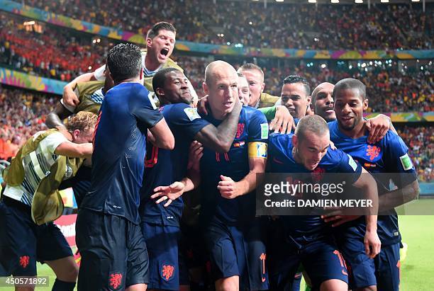 Netherlands' forward Arjen Robben and his team-mates celebrate after Robben scored their fifth goal during a Group B football match between Spain and...