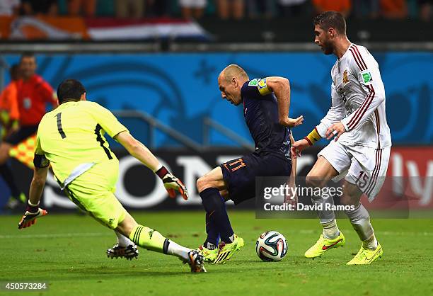 Arjen Robben of the Netherlands controls the ball on his way to scoring his second goal and the team's fifth against goalkeeper Iker Casillas and...