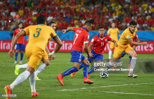 Alexis Sanchez of Chile shoots and scores his team's first goal during the 2014 FIFA World Cup Brazil Group B match between Chile and Australia at...