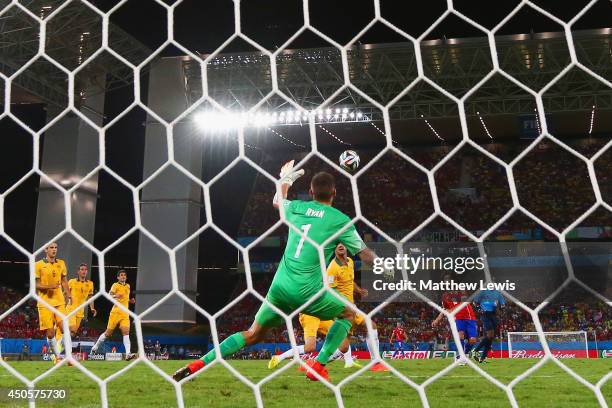 Jorge Valdivia of Chile shoots and scores his team's second goal against goalkeeper Mathew Ryan of Australia during the 2014 FIFA World Cup Brazil...
