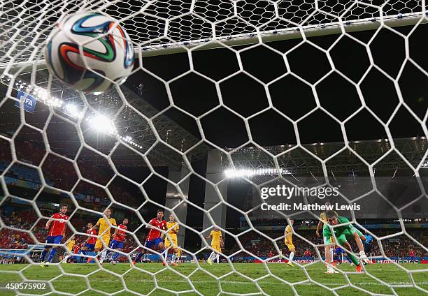 Jorge Valdivia of Chile shoots and scores his team's second goal against goalkeeper Mathew Ryan of Australia during the 2014 FIFA World Cup Brazil...
