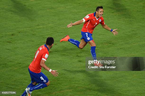 Alexis Sanchez of Chile celebrates scoring the team's first goal with Mauricio Isla during the 2014 FIFA World Cup Brazil Group B match between Chile...