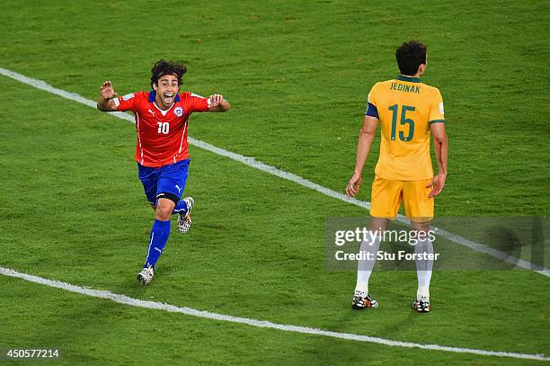 Jorge Valdivia of Chile celebrates after scoring the team's second goal as Mile Jedinak of Australia looks on during the 2014 FIFA World Cup Brazil...