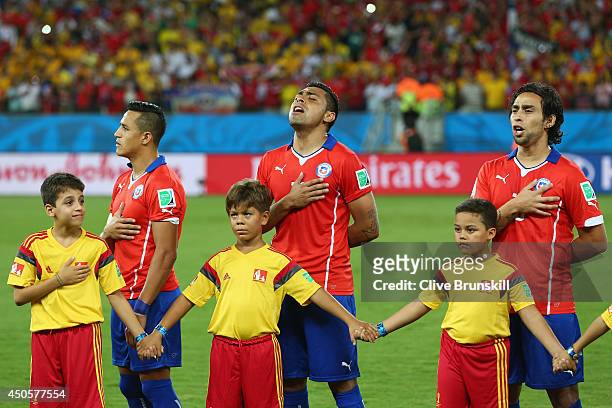 Alexis Sanchez, Arturo Vidal and Jorge Valdivia of Chile sing the National Anthem before the 2014 FIFA World Cup Brazil Group B match between Chile...