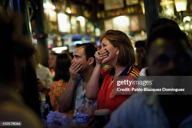 Spanish soccer fans react as they watch the Netherlands scoring a goal against their team in a Madrid tavern during Spain's first FIFA World Cup...