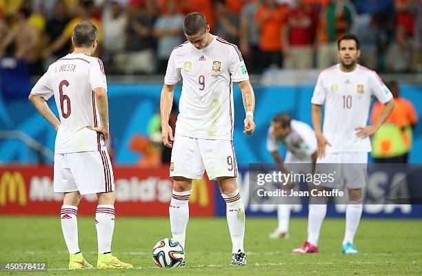 Andres Iniesta, Fernando Torres and Cesc Fabregas of Spain look dejected during the 2014 FIFA World Cup Brazil Group B match between Spain and...