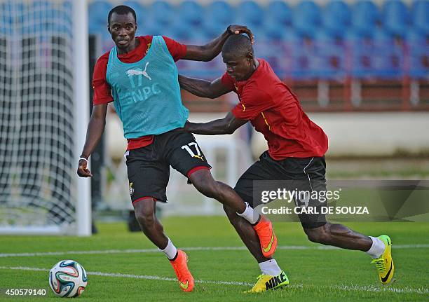 Ghana's midfielder Mohammed Rabiu and Ghana's defender Jonathan Mensah vie for the ball during a training session at the Rei Pele Stadium in Maceio,...