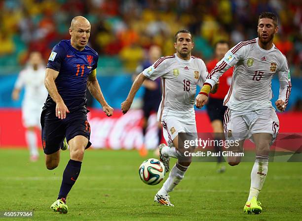 Arjen Robben of the Netherlands beats Sergio Ramos and Jordi Alba during the 2014 FIFA World Cup Brazil Group B match between Spain and Netherlands...