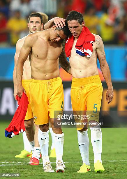 Tim Cahill and Mark Milligan of Australia embrace after being defeated by Chile 3-1 during the 2014 FIFA World Cup Brazil Group B match between Chile...