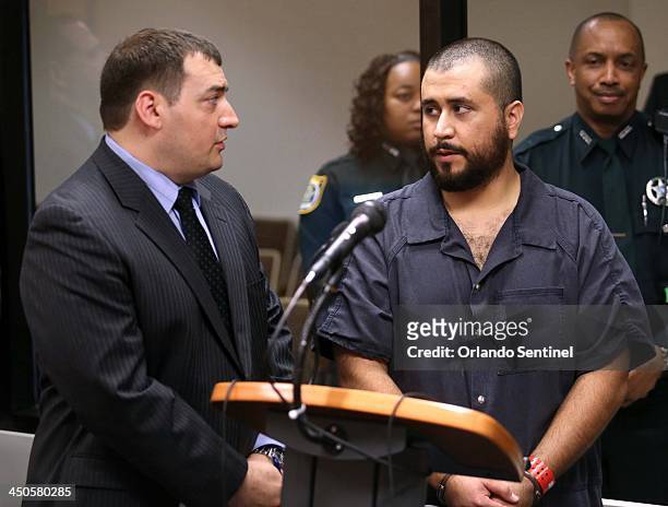 George Zimmerman, the acquitted shooter in the death of Trayvon Martin, talks with his defense counsel Daniel Megaro, left, during a first-appearance...