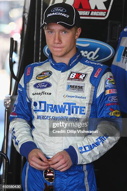 Tyler Reddick, driver of the DrawTite Ford waits in the garage during practice for the NASCAR Camping World Truck Series Drivin' for Linemen 200 at...