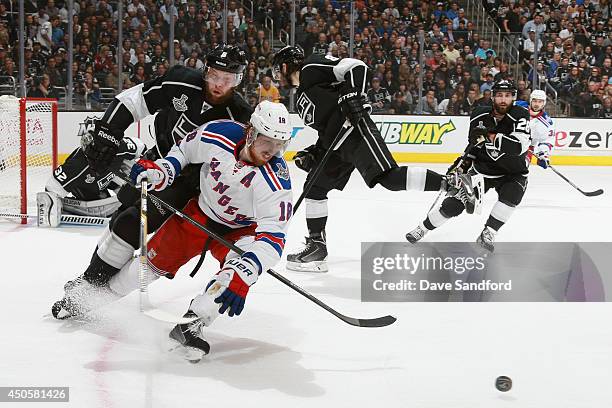 Marc Staal of the New York Rangers is pressures by Jake Muzzin of the Los Angeles Kings during the first period of Game Five of the 2014 Stanley Cup...