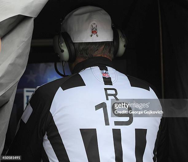 National Football League referee Scott Green looks at the monitor used to review challenged plays in the instant replay booth before a game between...