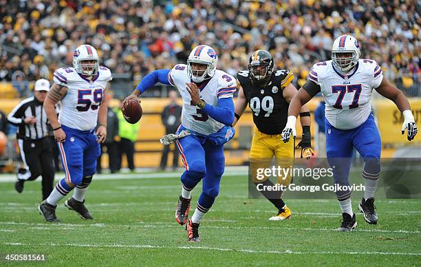 Quarterback EJ Manuel of the Buffalo Bills runs with the football as teammates Doug Legursky and Cordy Glenn and defensive lineman Brett Keisel of...