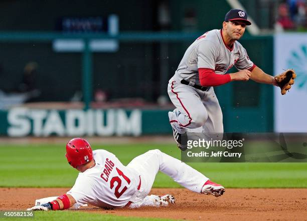 Danny Espinosa of the Washington Nationals leaps over Allen Craig of the St. Louis Cardinals as he completes the double play during the second inning...