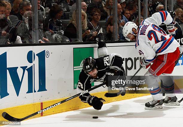 Jarret Stoll of the Los Angeles Kings dives for the puck in front of Dominic Moore of the New York Rangers in the second period of Game Five of the...