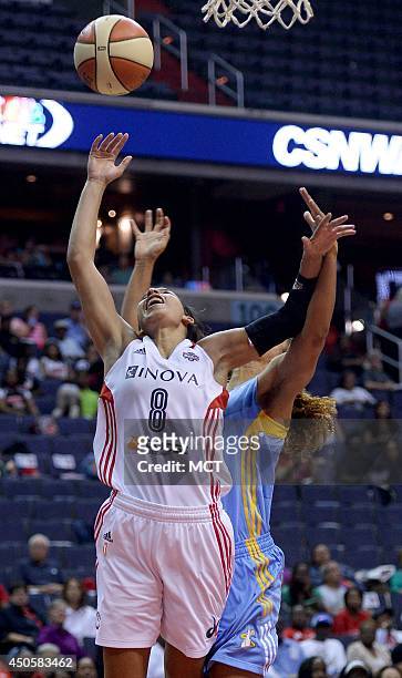 Washington Mystics guard Bria Hartley gets fouled from behind by Chicago Sky guard Courtney Clements in the second quarter at the Verizon Center in...
