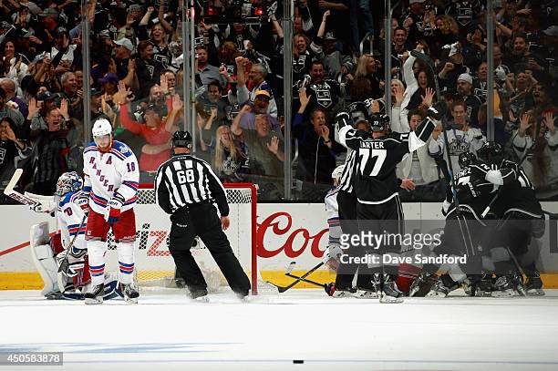 Marian Gaborik of the Los Angeles Kings celebartes his power play goal with teammates and goaltender Henrik Lundqvist and Brad Richards of the New...