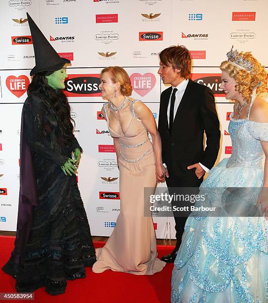 Actress Nicole Kidman and Keith Urban talk with Jemma Rix who plays Elphaba from the production 'WICKED' as Lucy Durack who plays Glinda looks on...