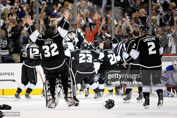 Alec Martinez of the Los Angeles Kings and the Kings celebrate after scoring the game-winning goal in double overtime against the New York Rangers to...