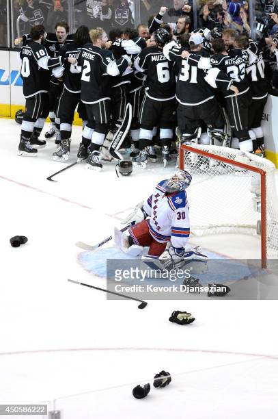 Alec Martinez of the Los Angeles Kings and the Kings celebrate after scoring the game-winning goal in double overtime against the New York Rangers to...