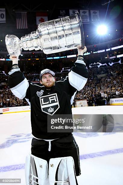 Jonathan Quick of the Los Angeles Kings celebrates with the Stanley Cup after the Kings 3-2 double overtime victory against the New York Rangers in...