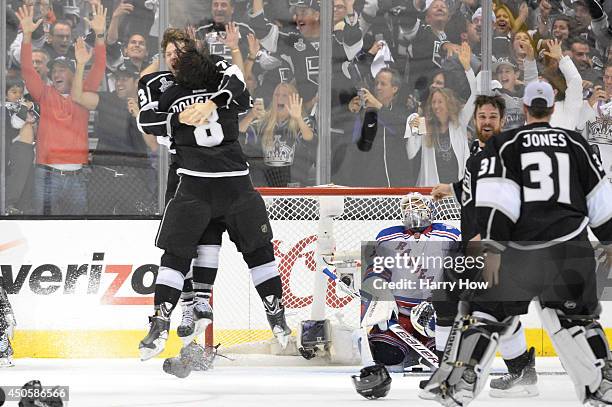 Tyler Toffoli and Drew Doughty of the Los Angeles Kings celebrate after teammate Alec Martinez scores the game-winning goal in double overtime...