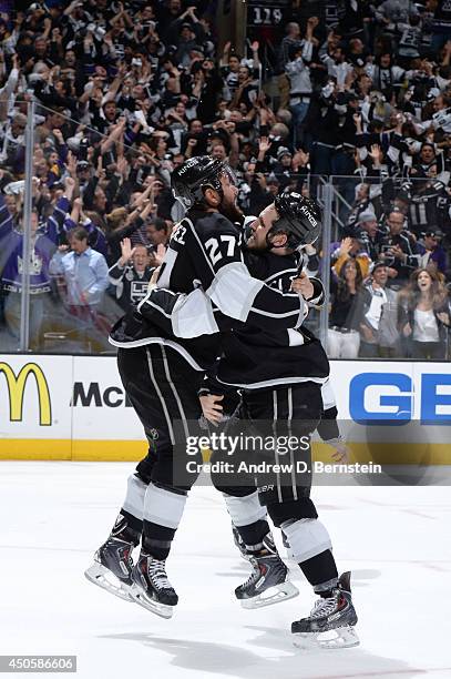 Alec Martinez and Kyle Clifford of the Los Angeles Kings celebrate after Martinez scored the game-winning goal against the New York Rangers in the...