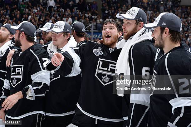 Jonathan Quick and Jake Muzzin of the Los Angeles Kings react after defeating the New York Rangers in the the second overtime period of Game Five of...