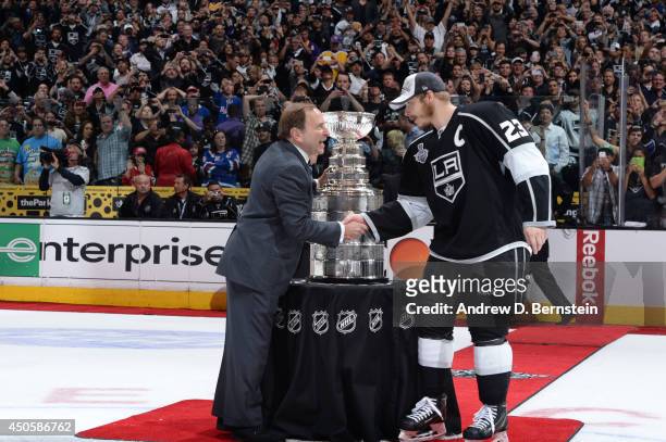 Commissioner Gary Bettman presents the Stanley Cup Trophy to the Dustin Brown of Los Angeles Kings following Game Five of the 2014 NHL Stanley Cup...