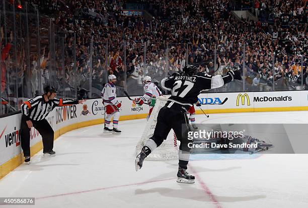Alec Martinez of the Los Angeles Kings celebrates after scoring the game-winning double overtime goal against goaltender Henrik Lundqvist of the New...