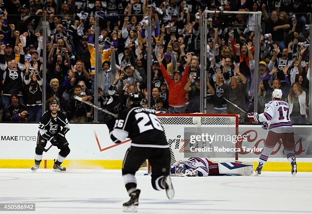 Alec Martinez of the Los Angeles Kings celebrates after scoring the game-winning double overtime goal against goaltender Henrik Lundqvist of the New...