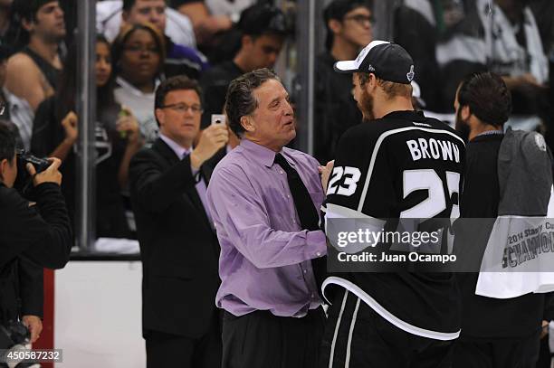 Los Angeles Kings general manager Dean Lombardi and captain Dustin Brown celebrate after defeating the New York Rangers in Game Five of the 2014 NHL...