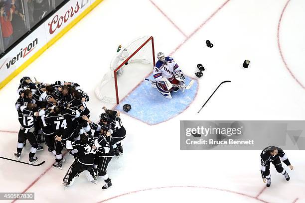 Alec Martinez of the Los Angeles Kings and the Kings celebrate after scoring the game-winning goal in double overtime against goaltender Henrik...
