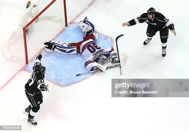 Alec Martinez of the Los Angeles Kings celebrates with Kyle Clifford after Martinez scores the game-winning goal in double overtime against...