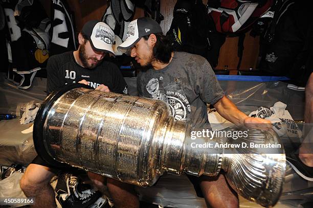 Mike Richards and Jordan Nolan of the Los Angeles Kings celebrate in the locker room after defeating the New York Rangers in the second overtime...