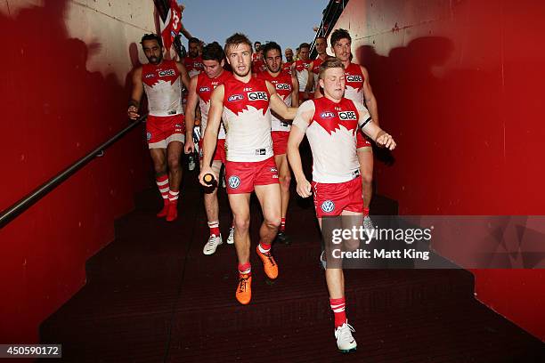 Kieren Jack of the Swans leads the Swans back through the race with Daniel Hannebery during the round 13 AFL match between the Sydney Swans and the...