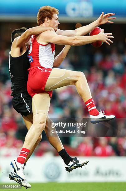 Gary Rohan of the Swans takes a mark over Jarman Impey of the Power during the round 13 AFL match between the Sydney Swans and the Port Adelaide...