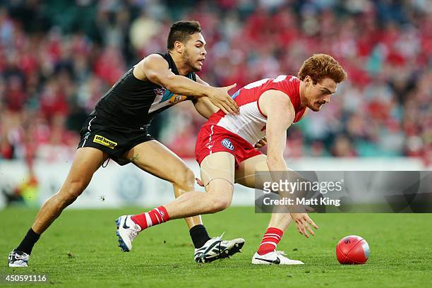 Gary Rohan of the Swans competes for the ball against Jarman Impey of the Power during the round 13 AFL match between the Sydney Swans and the Port...