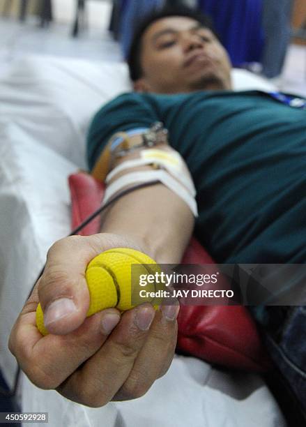 Man donates blood to the Philippine Red Cross at a mall in Manila on June 14, 2014 as the world celebrates World Blood Donor Day. The World Health...