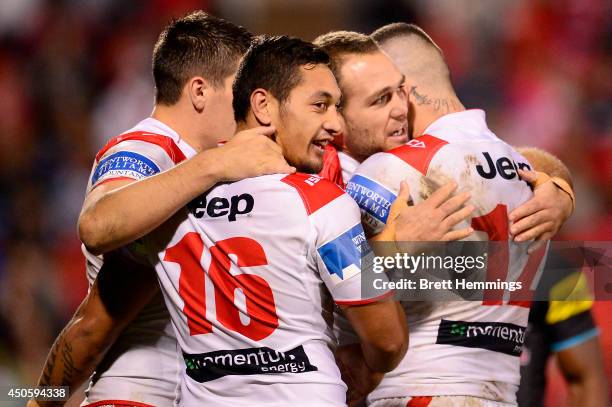 Jason Nightingale of the Dragons celebrates with team mates after scoring during the round 14 NRL match between the Penrith Panthers and the St...