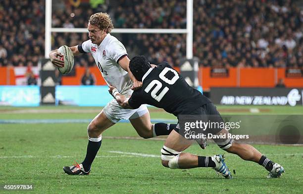 Billy Twelvetrees of England is tackled by Victor Vito during the International Test Match between the New Zealand All Blacks and England at Forsyth...