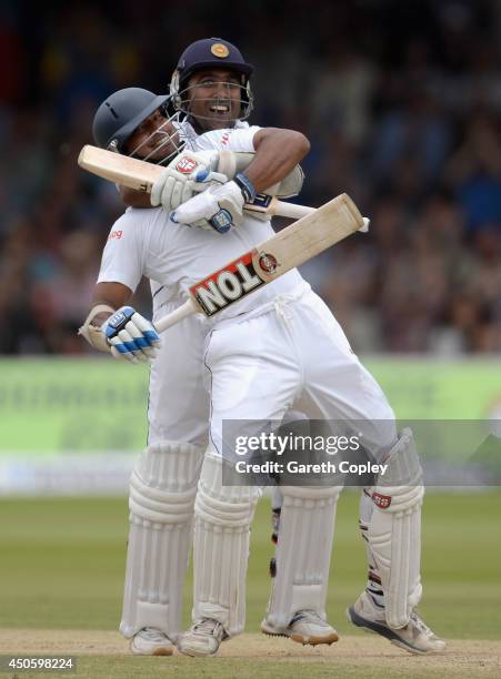 Kumar Sangakkara of Sri Lanka celebrates reaching his century with teammate Mahela Jayawardena during day three of 1st Investec Test match between...