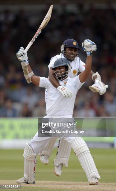 Kumar Sangakkara of Sri Lanka celebrates reaching his century with teammate Mahela Jayawardena during day three of 1st Investec Test match between...